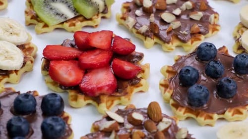 Delicious Waffles Topped with Fruit and Chocolate Spread