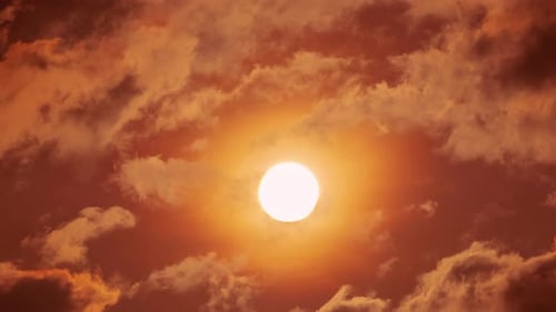 Warm Sun Shining Through Clouds at Sunset