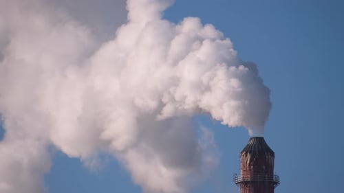 Industrial Smokestack Spewing White Smoke into Blue Sky