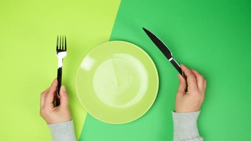 Arranging Knife and Fork on Green Plate