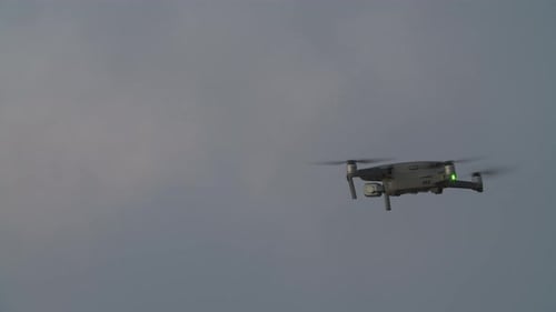 Quadrocopter Flying Against Evening Sky