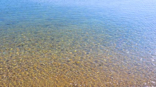 Gentle Ocean Waves Lapping onto a Sandy Beach