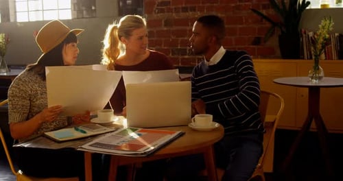 Colleagues Discussing Business at Modern Workplace