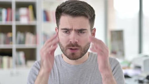 Young Man Massaging Temples to Relieve Headache