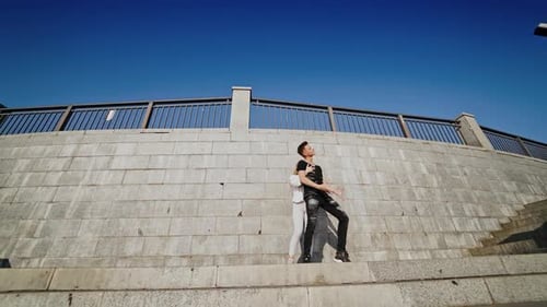 Dynamic Couple Dancing on Urban Concrete Steps