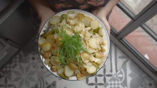 Overhead Shot of Cooked Potatoes Held by Woman