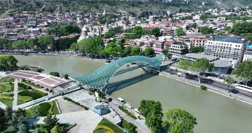 Aerial view of Tbilisi city central park and Bridge of Peace. Beautiful cityscape of old Tbilisi
