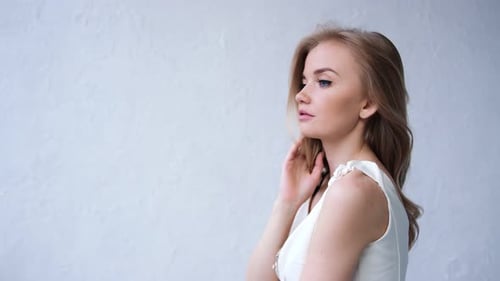 Blonde Woman Posing in a White Dress