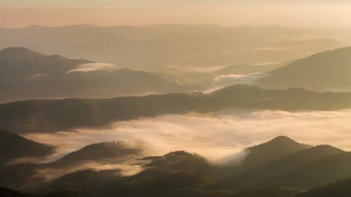 Aerial View of Misty Mountains at Sunrise