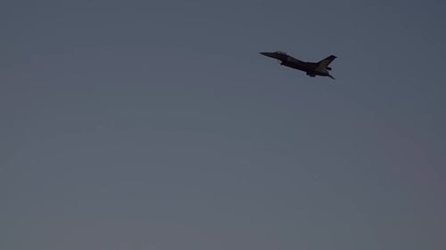 Jet Plane Flies Through the Light Blue Sky