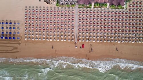 Aerial view of amazing beach with colourful umbrellas and turquoise sea