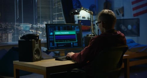 Teen Hacker Works on Computer at Night