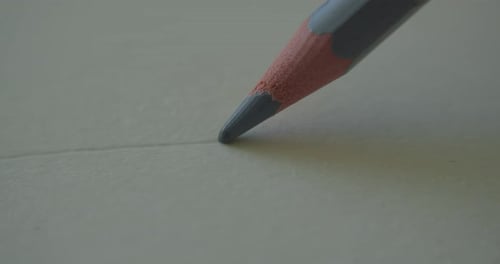 Pencil Draws a Line on Paper Close Up
