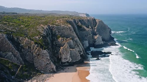 Aerial View of Rocky Wall Formation on Praia Grande Beach Located on Portugal Coastline with