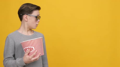 Teen Boy Wearing 3D Glasses Looking Aside Over Yellow Background