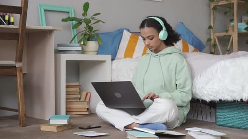 Young Woman Studies on Laptop in Bedroom