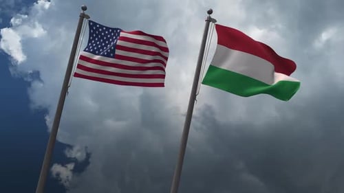 United States and Hungary Flags Waving Against Cloudy Sky