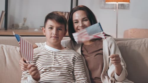Mother and Child Celebrate Holding American Flags