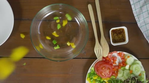 young chief woman tossing a tasty organic green salad.