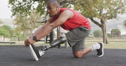 Side view man with prosthetic leg stretching