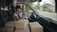 Delivery Woman Taking Notes Inside a Van