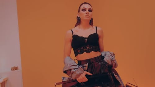 Confident Woman Poses with a Boombox in Studio