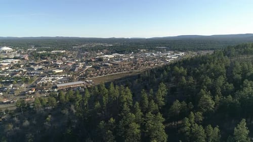 Aerial View of City Bordering Forest and Hills