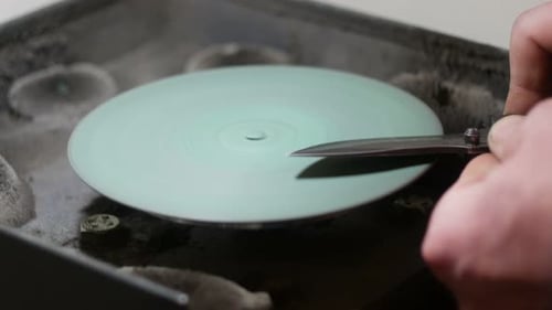 Knife Blade Being Sharpened on Grinder Close Up