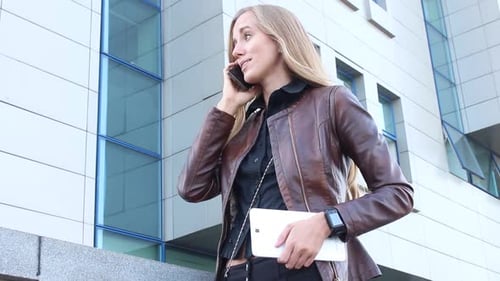 Modern Woman Talking On The Phone In The City