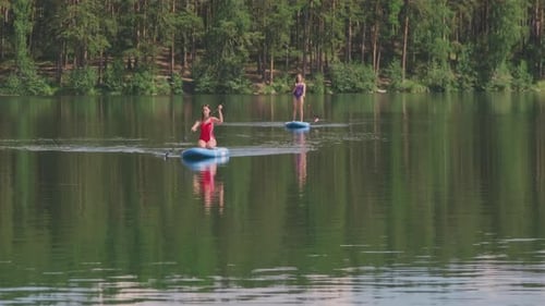 Women Rowing on Lake