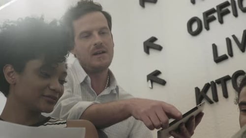 Team Collaborating in Modern Office with Tablet Device