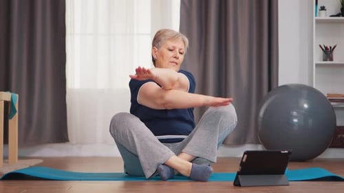 Woman Performing Arm Stretches at Home