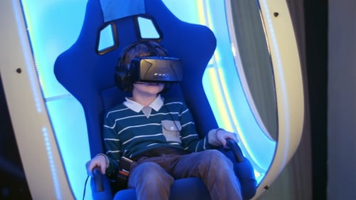 Child Enjoys Virtual Reality in Futuristic Chair