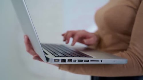 Typing on laptop, close up. Close up of female hands typing text on laptop keyboard