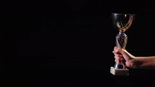 Hand with the Winner's Cup on a Seren Background