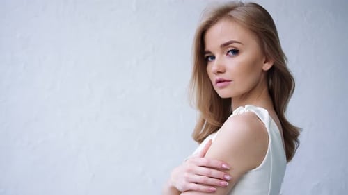 Elegant Woman Posing in White Dress Indoors