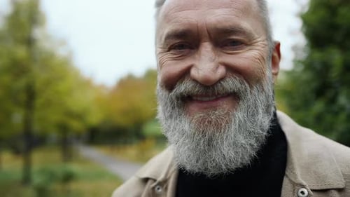 Close Up Portrait of Bearded Man Looking at Camera Outdoors