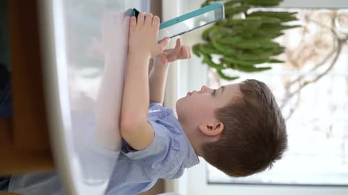 Boy Using Tablet at Home During Daytime