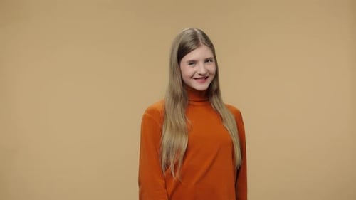 Young Woman Smiling on Beige Background