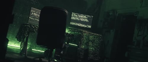 Dark Urban Room with Computers Displaying Code