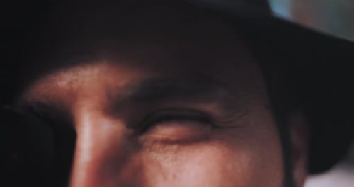 Photographer focuses then looks at subject