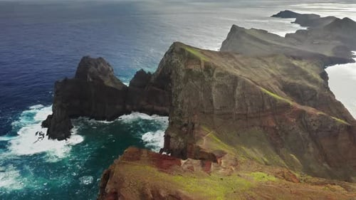 Scenic Bare Conical Hills Arcing Around a Bay of Crystalline Water