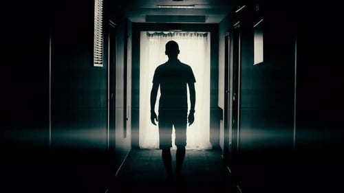 Man Walk Down a Corridor