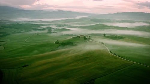 Flying over the foggy Tuscany Italy landscape
