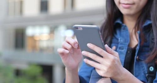 Woman Using Smartphone in Urban Setting