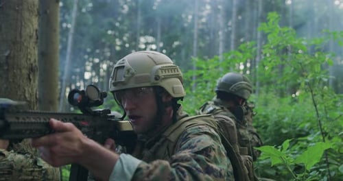 Soldiers with Rifles Patrolling Through Forest