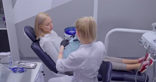 Dentist Preparing Young Adult Patient for Dental Cleaning