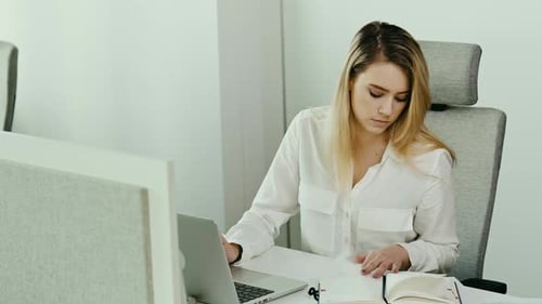 Woman Working on Laptop in Bright Modern Office