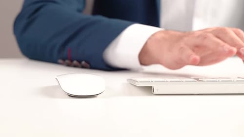 Office worker using keyboard and mouse.
