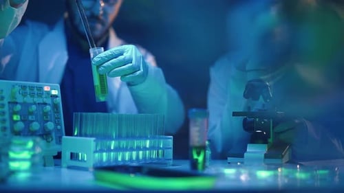Scientists Work in Modern Lab with Microscope and Test Tubes